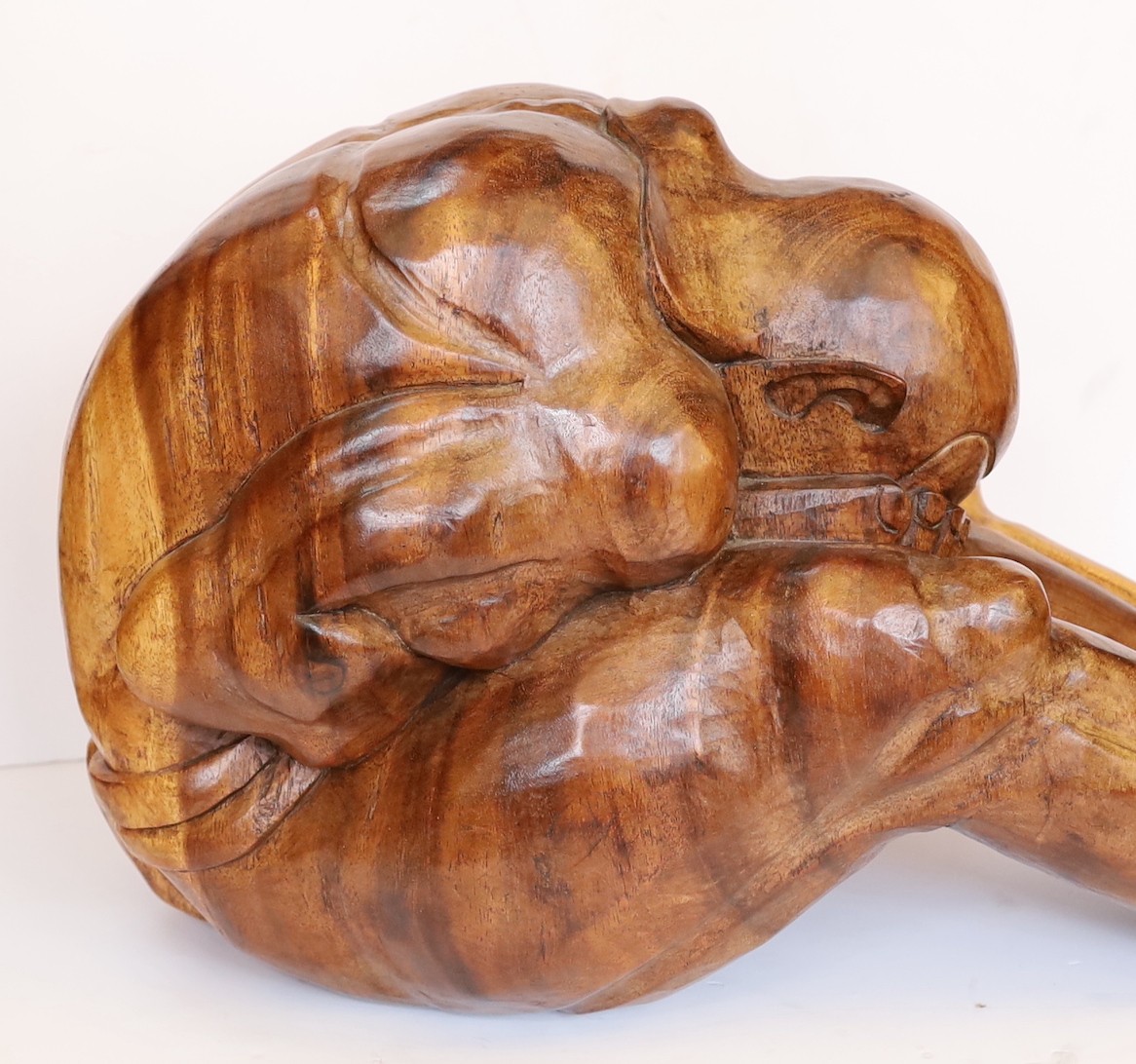 A Malaysian carved hardwood figure of the weeping Buddha, length 60cm. height 26cm